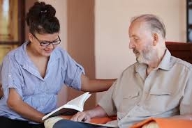 Woman volunteer supporting male patient