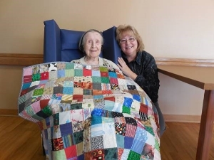 Allay Volunteer & Client with quilt