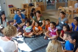 Volunteers read aloud to a small group of families