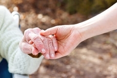 Elder hands with young hands