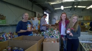 Volunteers sorting donated food.