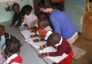 Volunteer working with children at Uganda school