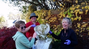 Volunteers cleaning sculptures at Cranbrook House and Garden