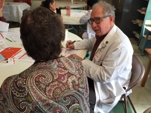 A volunteer physician educating a participant at a KEEP Heal