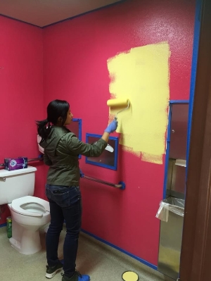 Volunteer painting a bathroom