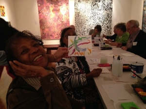 Program Participant Proudly Displaying her Work