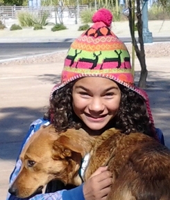 An ASCMV volunteer holds a dog. She frequently walks dogs fo